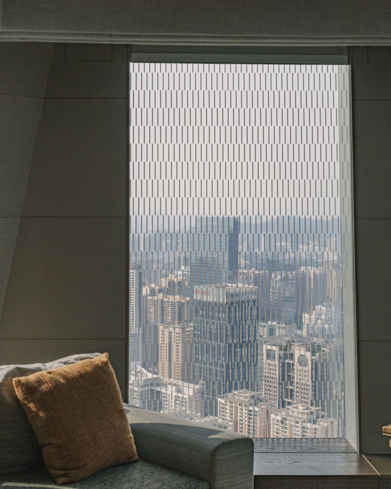 Cordless solar shade covering a floor-to-ceiling window, with no chain or pull on the fabric