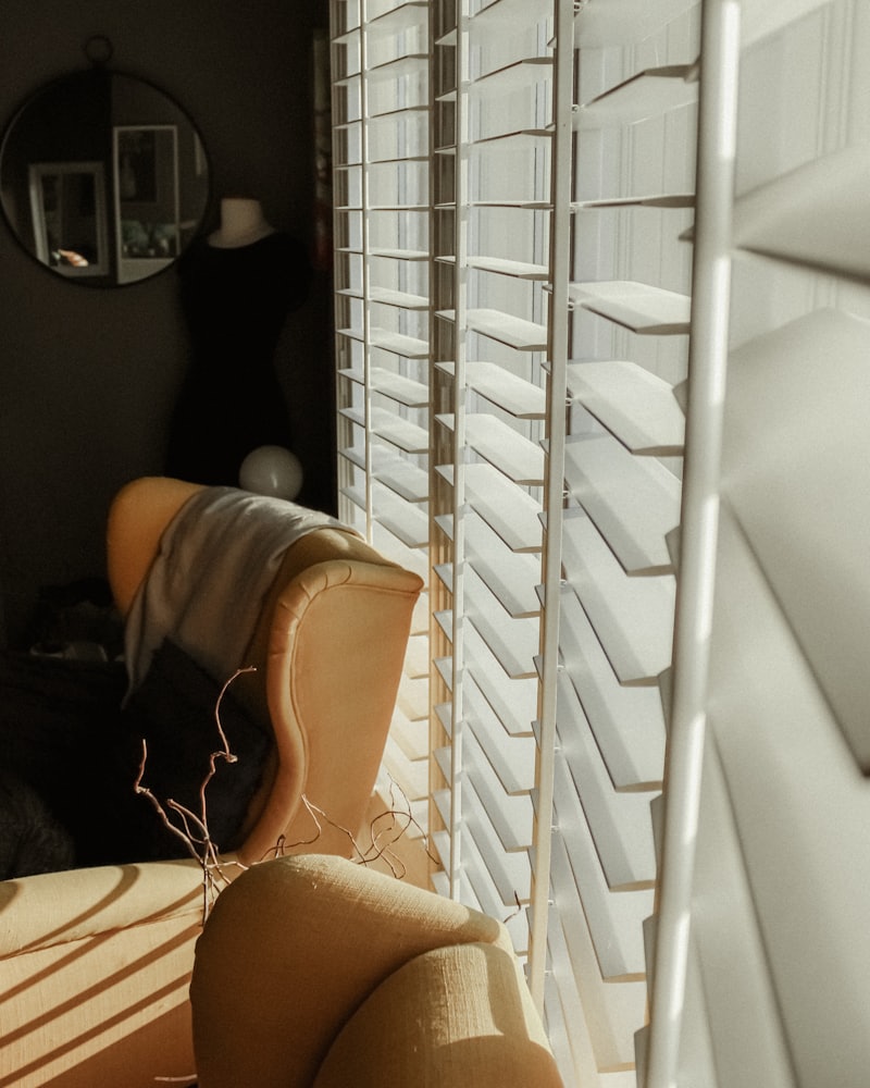 White plantation shutters open to afternoon light