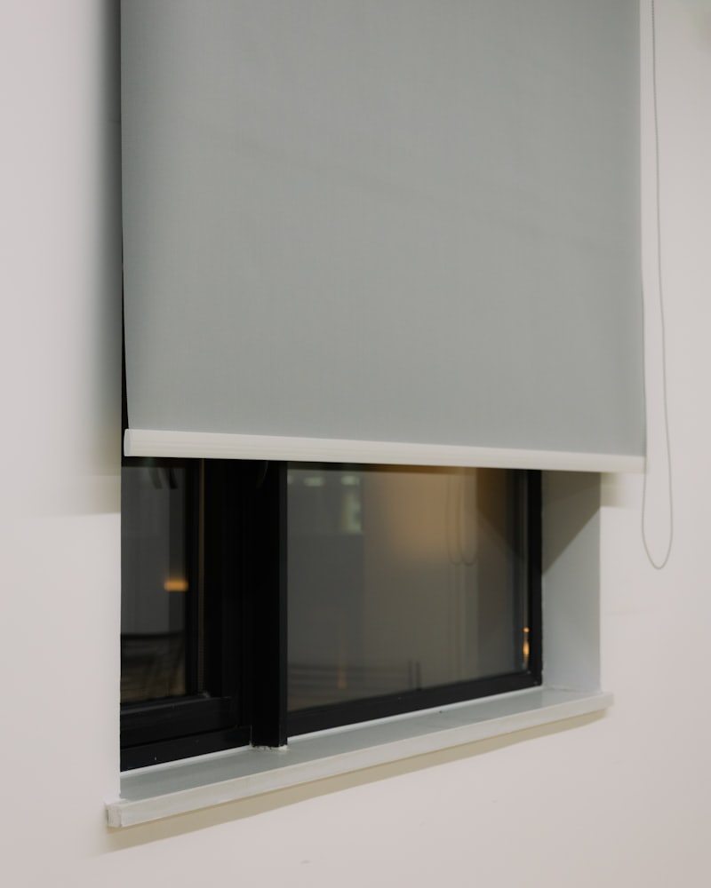 Solar roller shade lowered against bright afternoon light