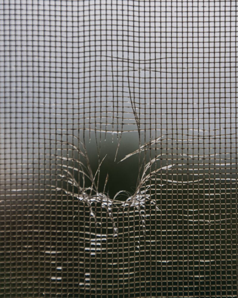 Window screen frame being re-meshed after wind damage
