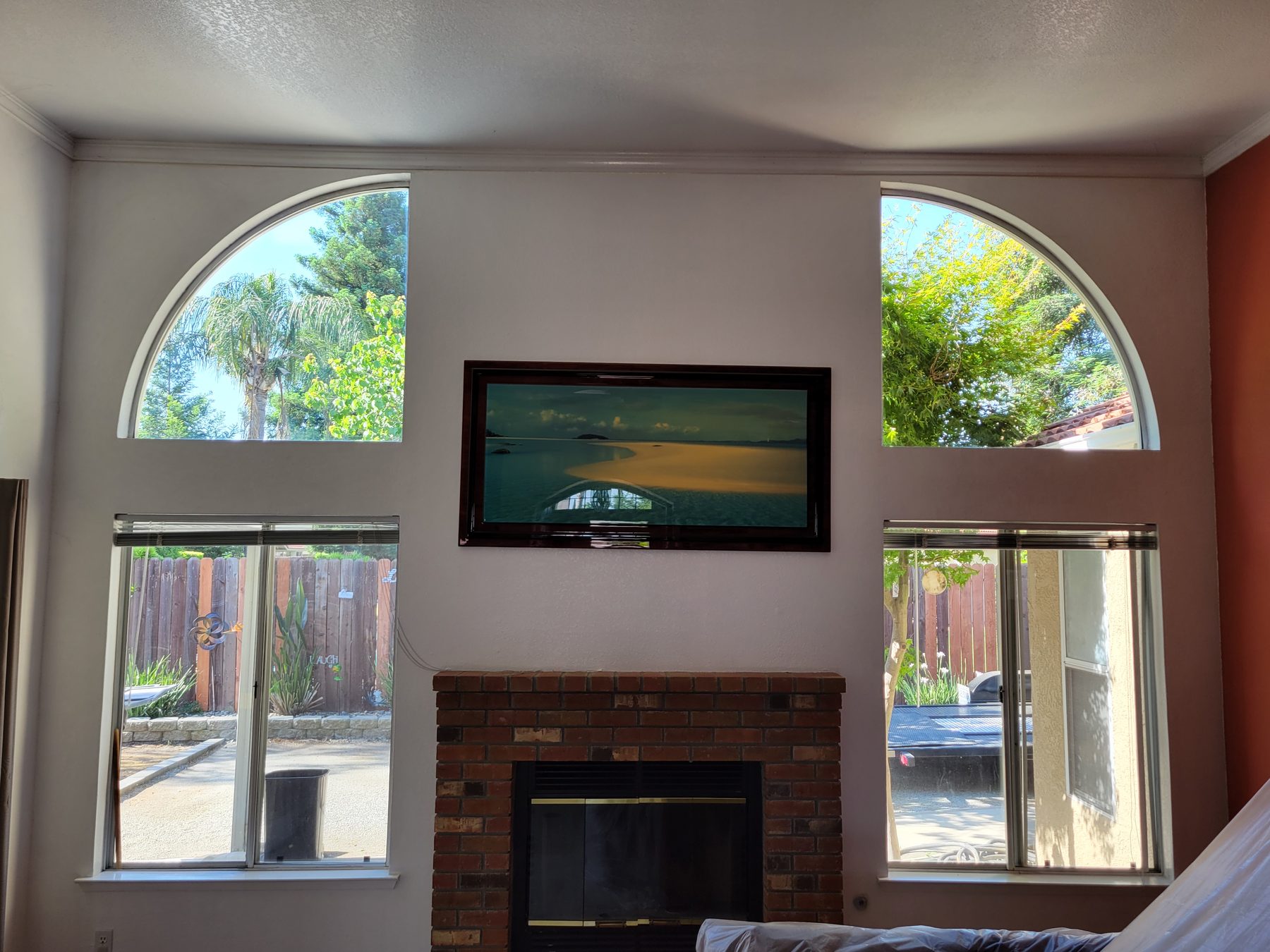Two arch-top windows either side of a chimney breast.