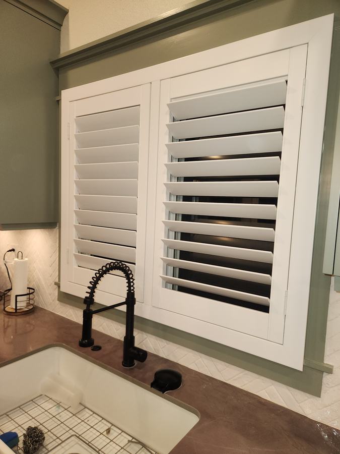 Shutter panel over a kitchen sink