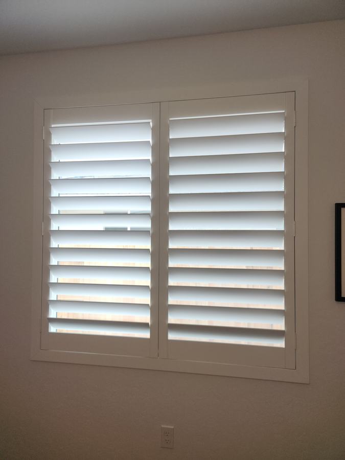 Bedroom shutters with a divider rail