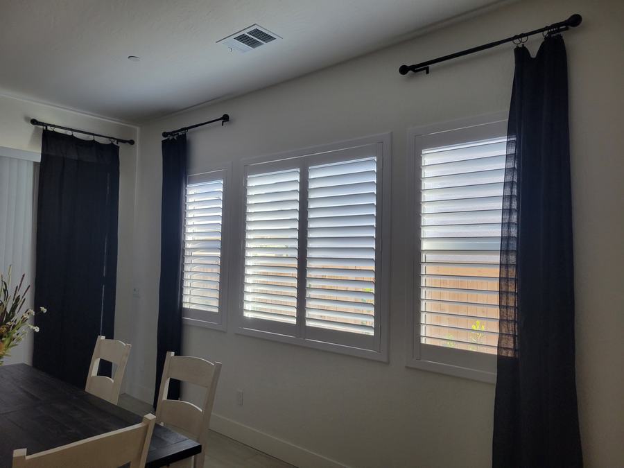 Dining room, shutters framed by drapery