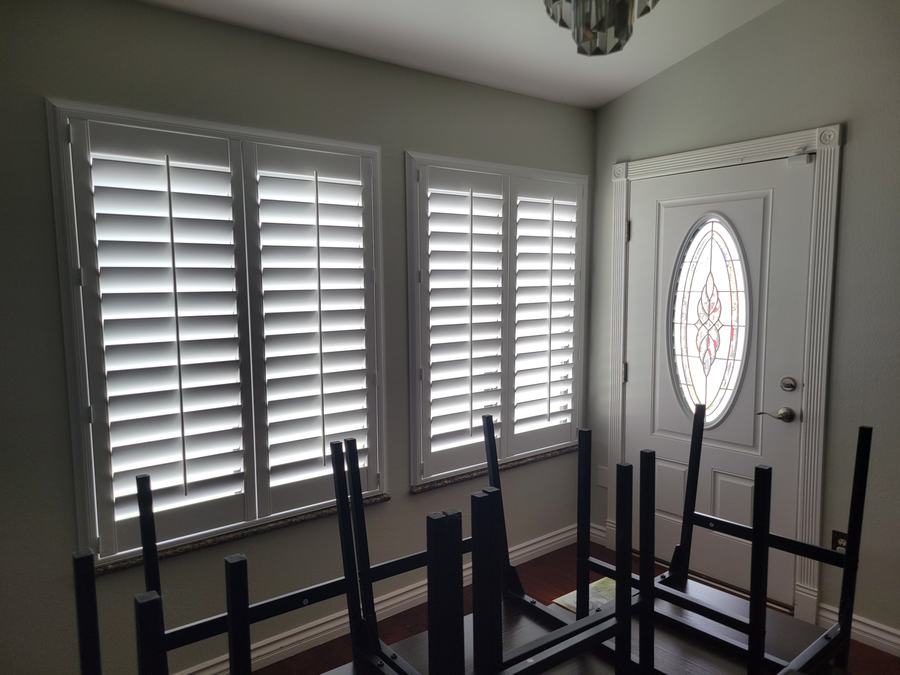 Dining shutters beside a leaded entry