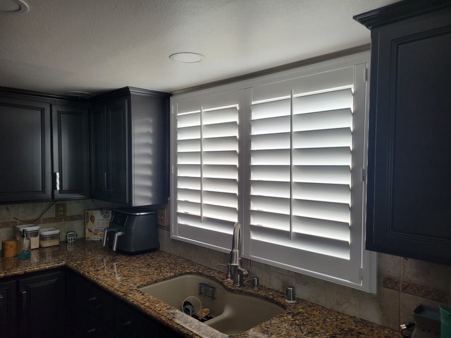 Kitchen shutters against navy cabinets