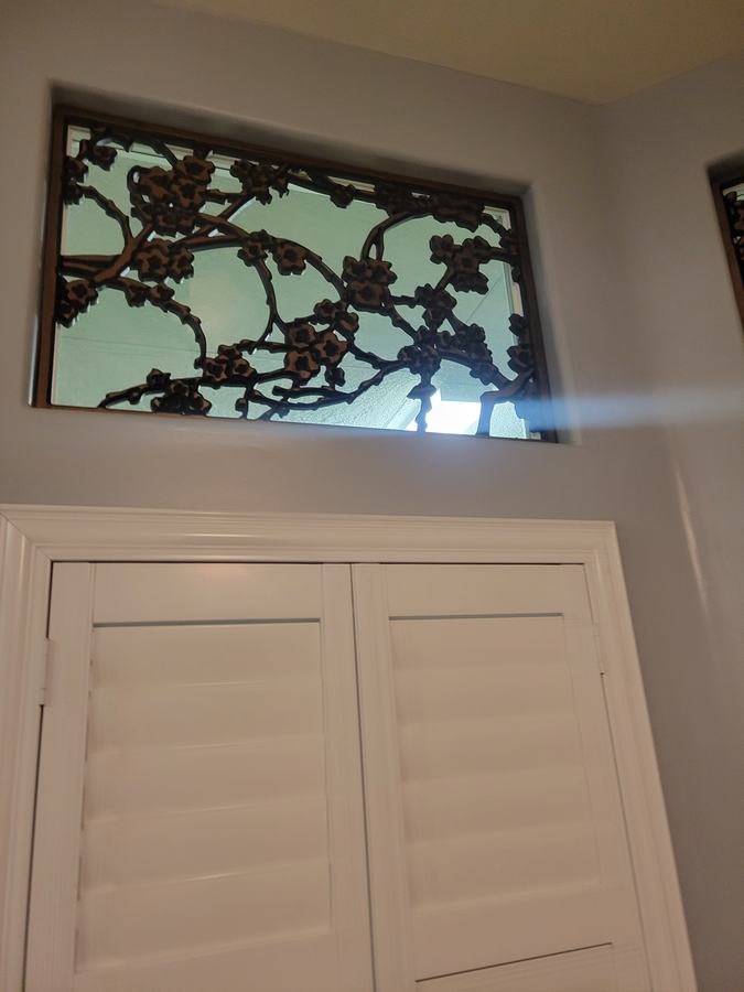 Cafe shutters under a leaded transom